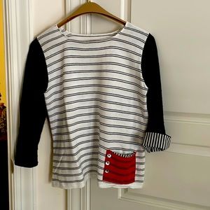 Beautiful black and white sweater with red pocket on front and back.